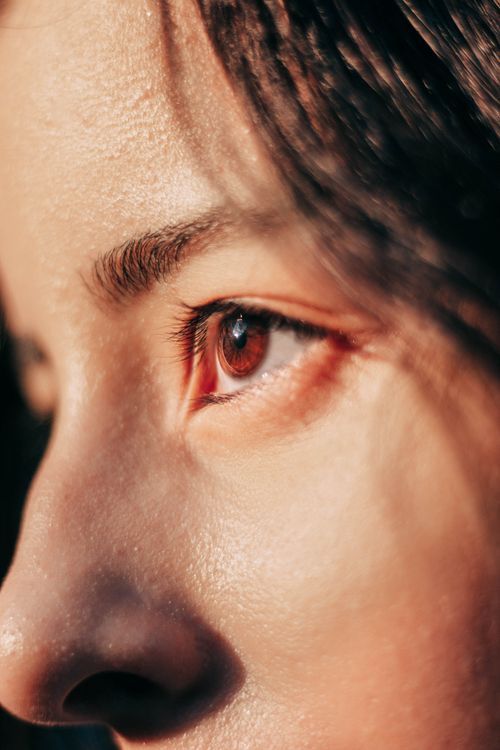 Free Close-up detail of a woman's eye captured in natural light, showcasing skin texture and eye detail. Stock Photo