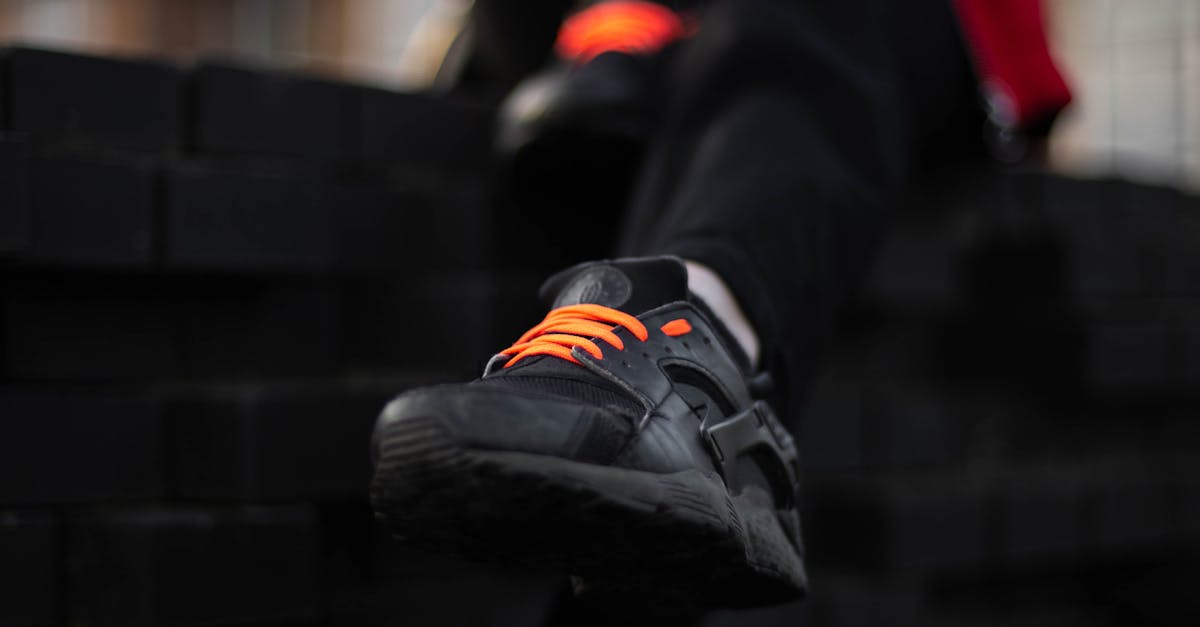 Person Wearing Black Nike Air Huarache Sneaker · Free