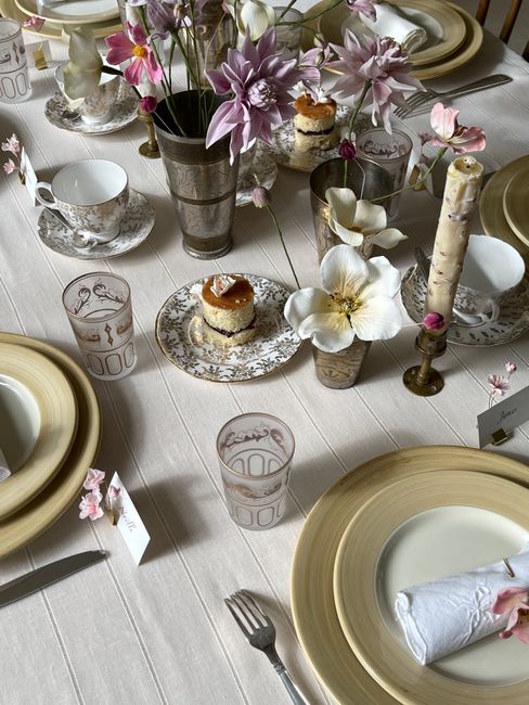 A sophisticated table setting featuring floral arrangements and vintage tableware for a formal dining experience.