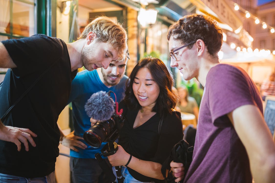 Free Three Men Watching Camera Holding by a Woman Stock Photo