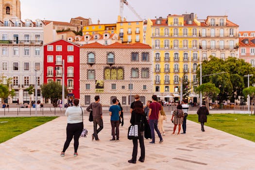 Vibrant Lisbon street scene featuring colorful buildings and a diverse group of tourists.