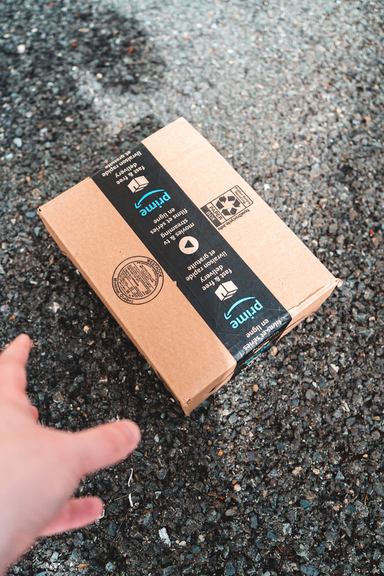 Amazon Prime Package Thrown On A Sidewalk Gravel