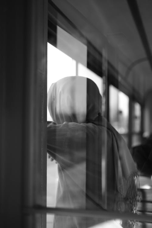 Woman in Hijab behind Window