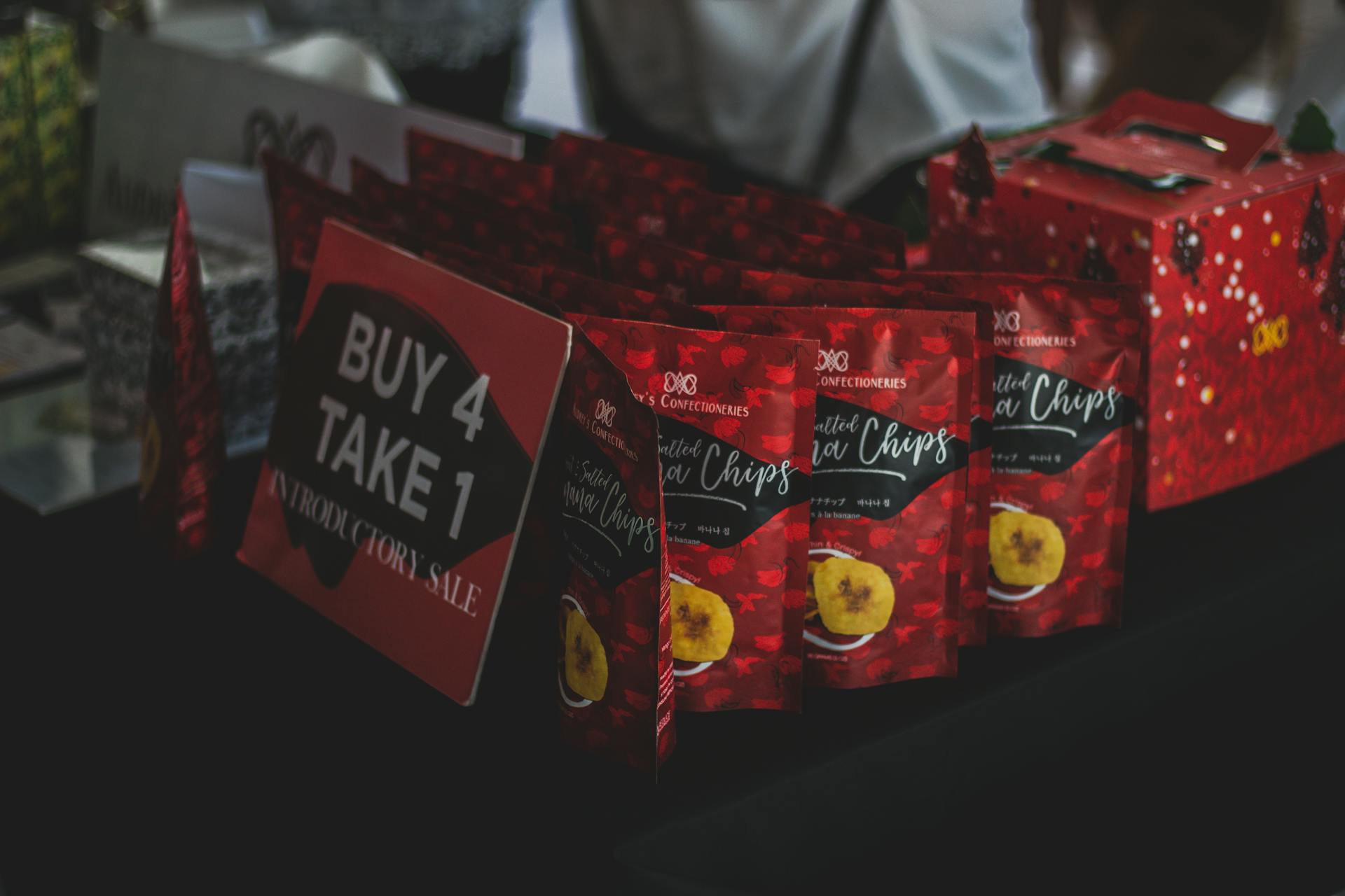Assorted Chip Packs on Black Surface in Tilt Shift Photography