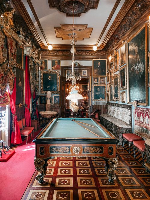 Free Elegant luxurious vintage room featuring an ornate billiards table and chandelier in Madrid. Stock Photo