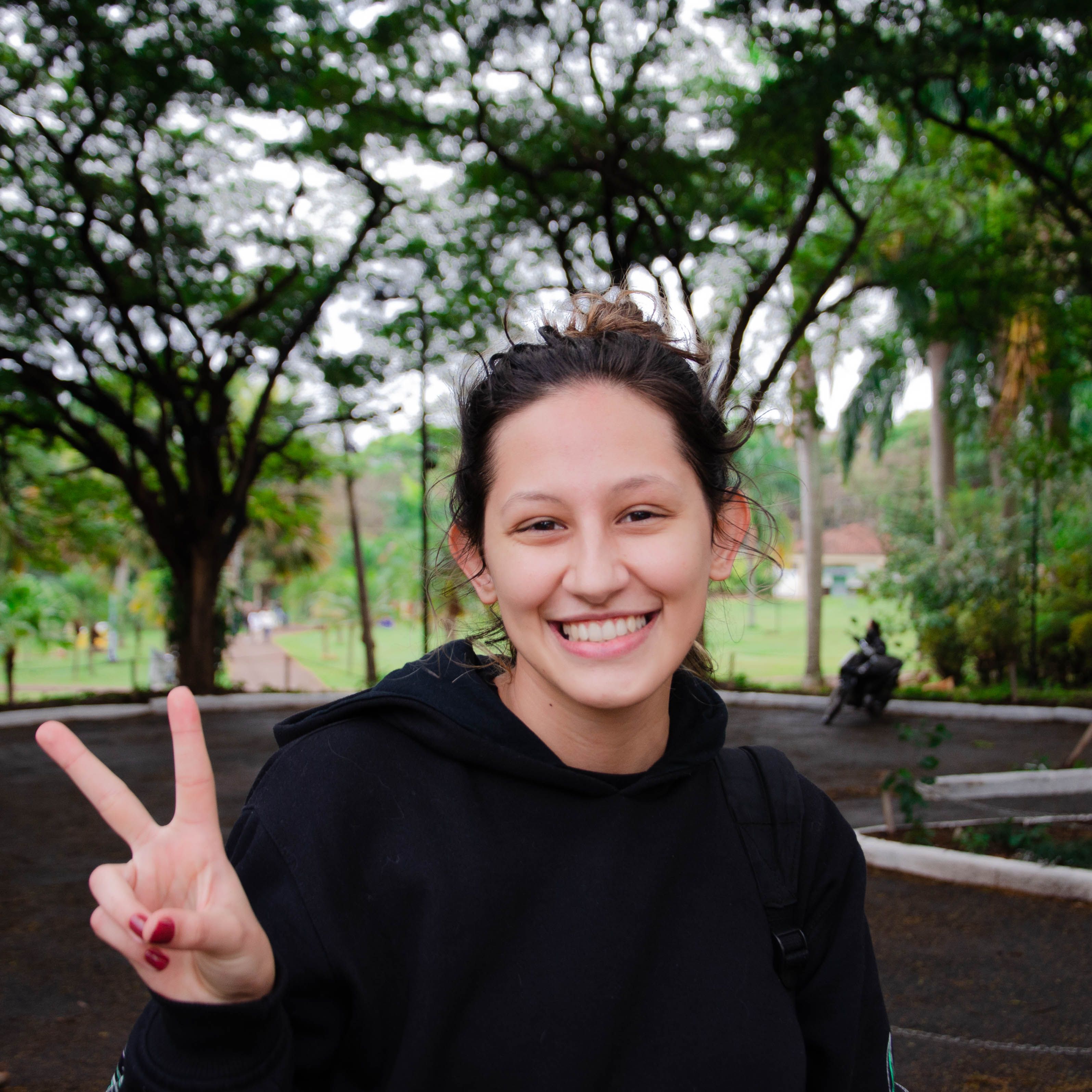 Smiling Woman Gesturing Victoria Finger Sign