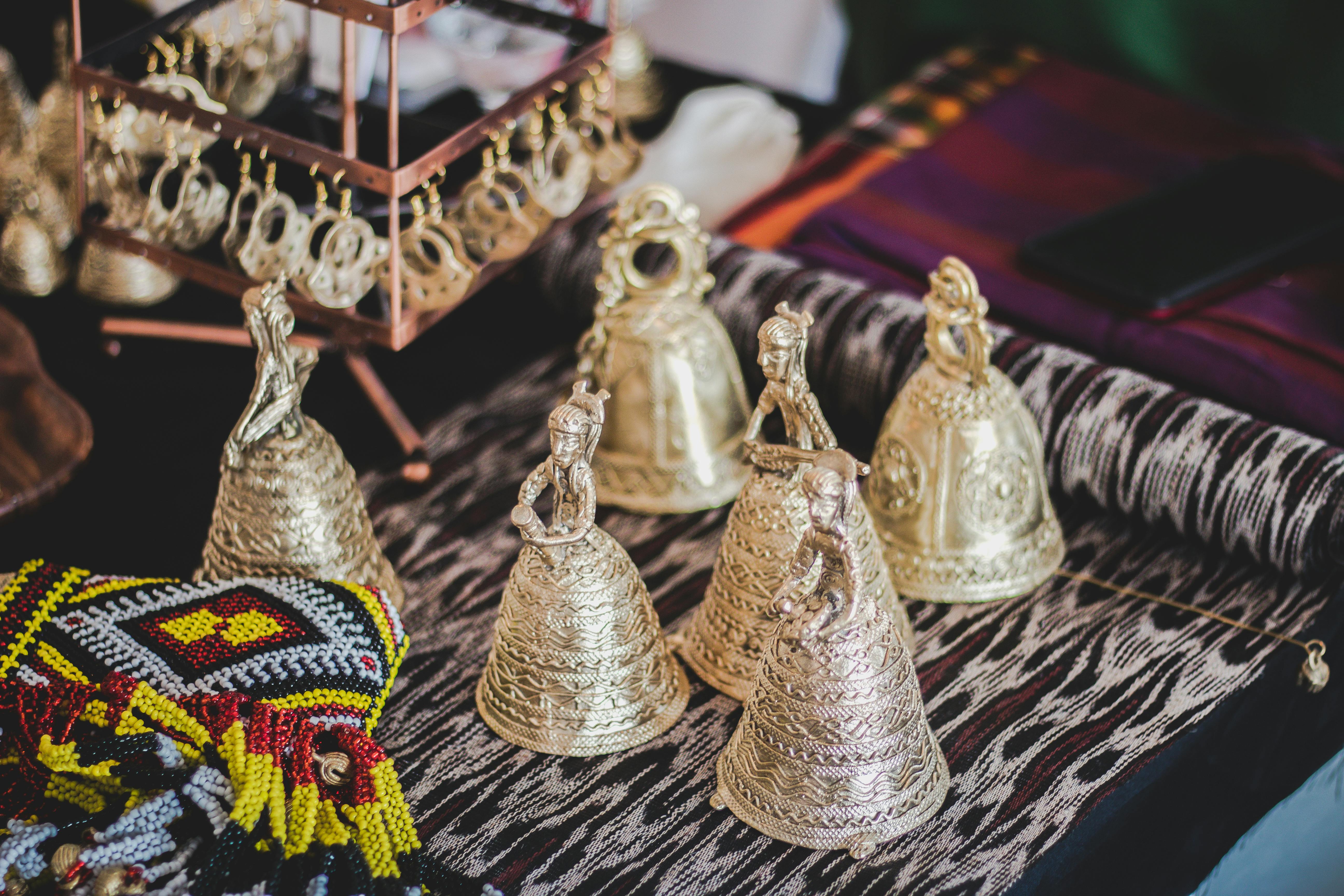 gold colored bells on gray and white textile