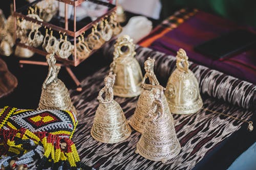 Gold-colored Bells on Gray and White Textile