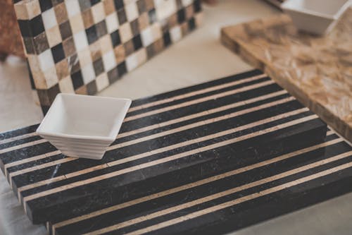 Square White Bowl and Black Wooden Surface