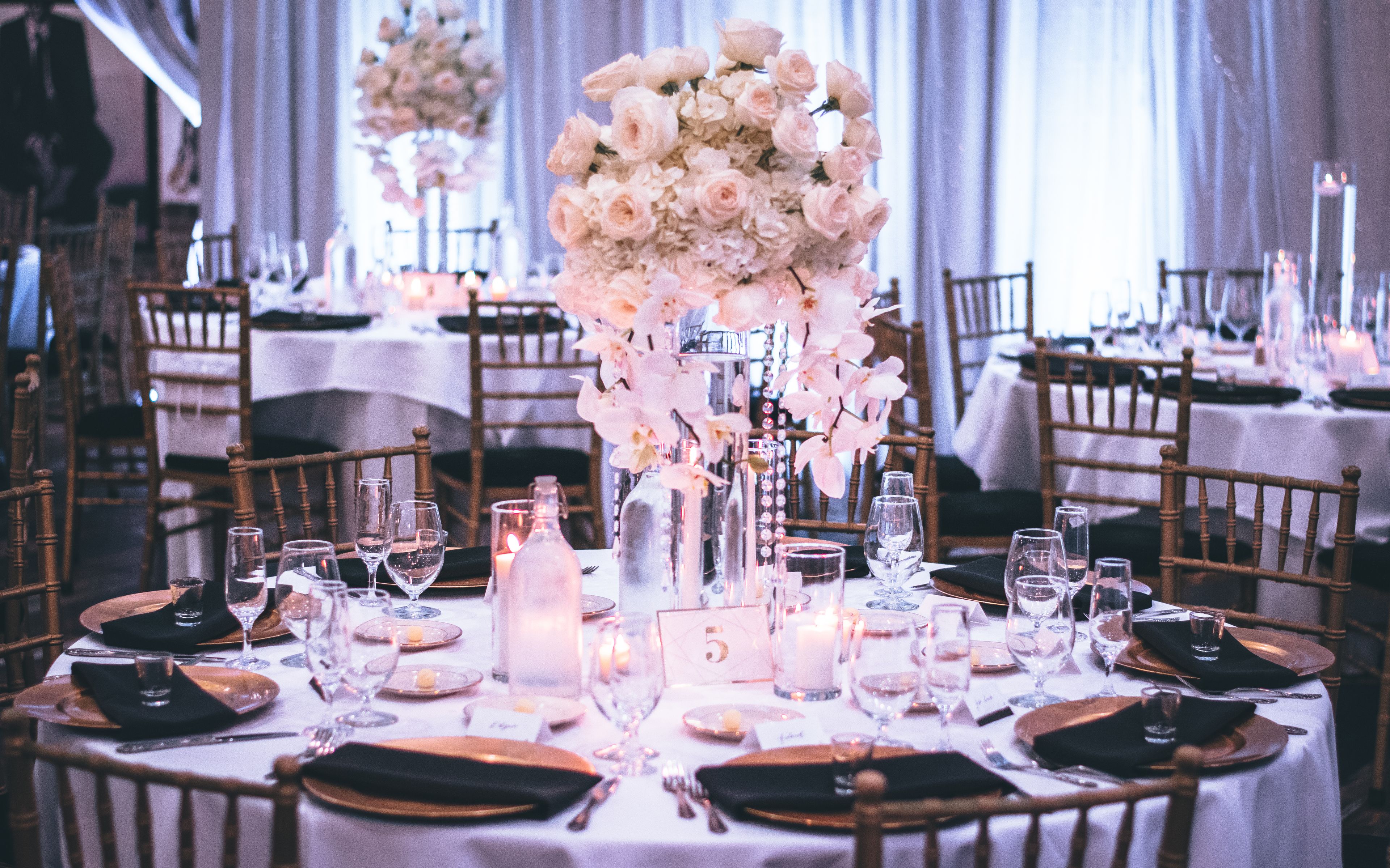 Long wedding table dressed with flowers and glassware