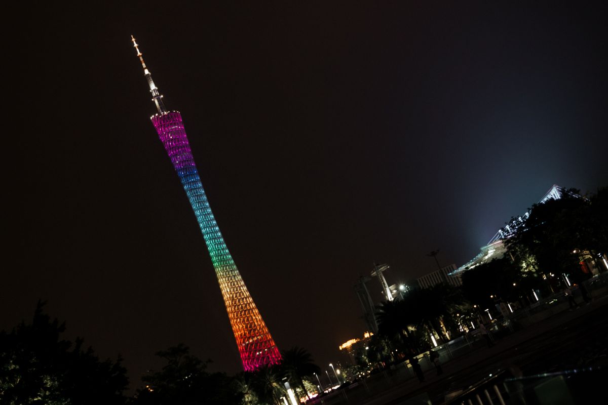 Vibrant night view of the illuminated Canton Tower in Guangzhou against a dark sky.