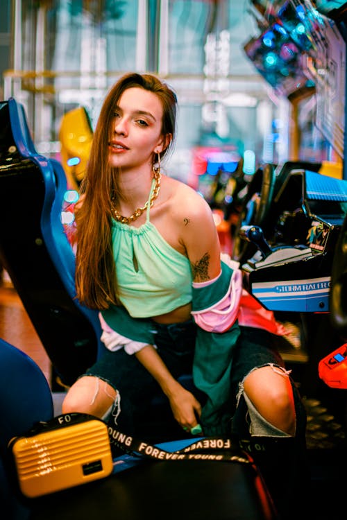 Girl Sitting in an Arcade 