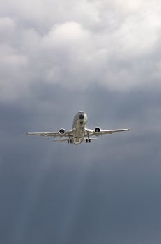 A commercial airplane flying through a cloudy sky in Bogotá, Colombia, capturing the aviation essence.