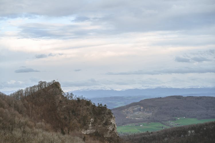 Landscape Of A Valley And Mountains In Distance 