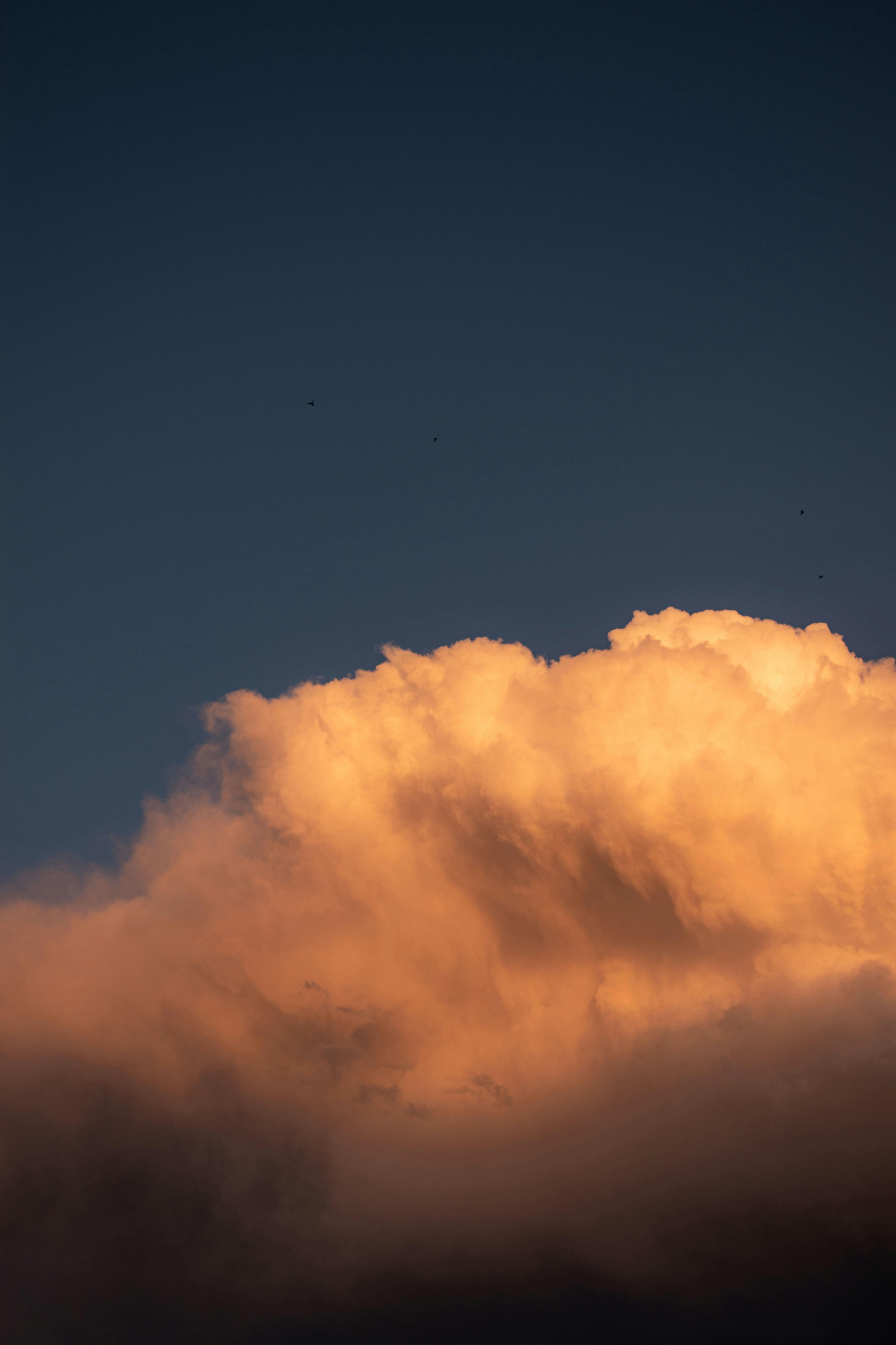 a cloud is seen in the sky at sunset