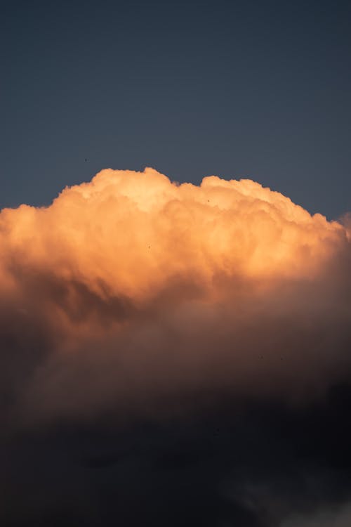 A cloud is seen in the sky at sunset