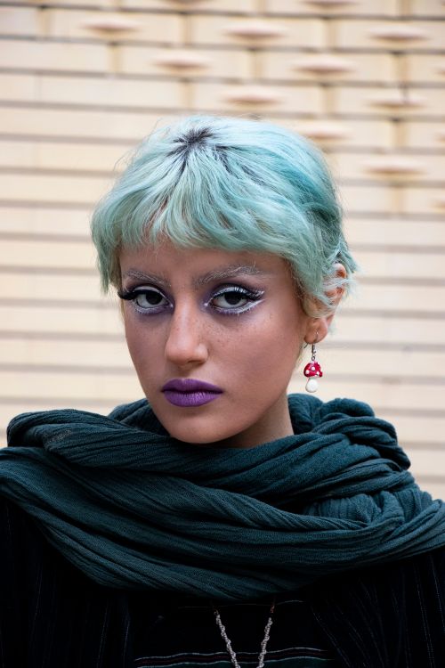Free Vibrant portrait of a woman in Tabriz, Iran with bold makeup and turquoise hair. Stock Photo