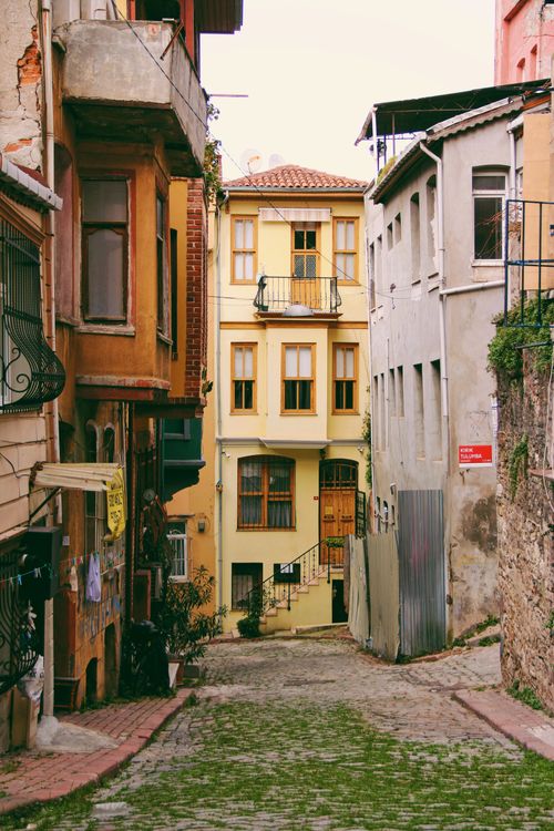 Free Explore a colorful, historical street in Fener, İstanbul, featuring pastel homes and cobblestone paths. Stock Photo