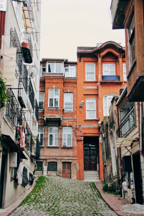 Free Explore the vibrant architecture of İstanbul's historic streets captured in this charming alleyway scene. Stock Photo