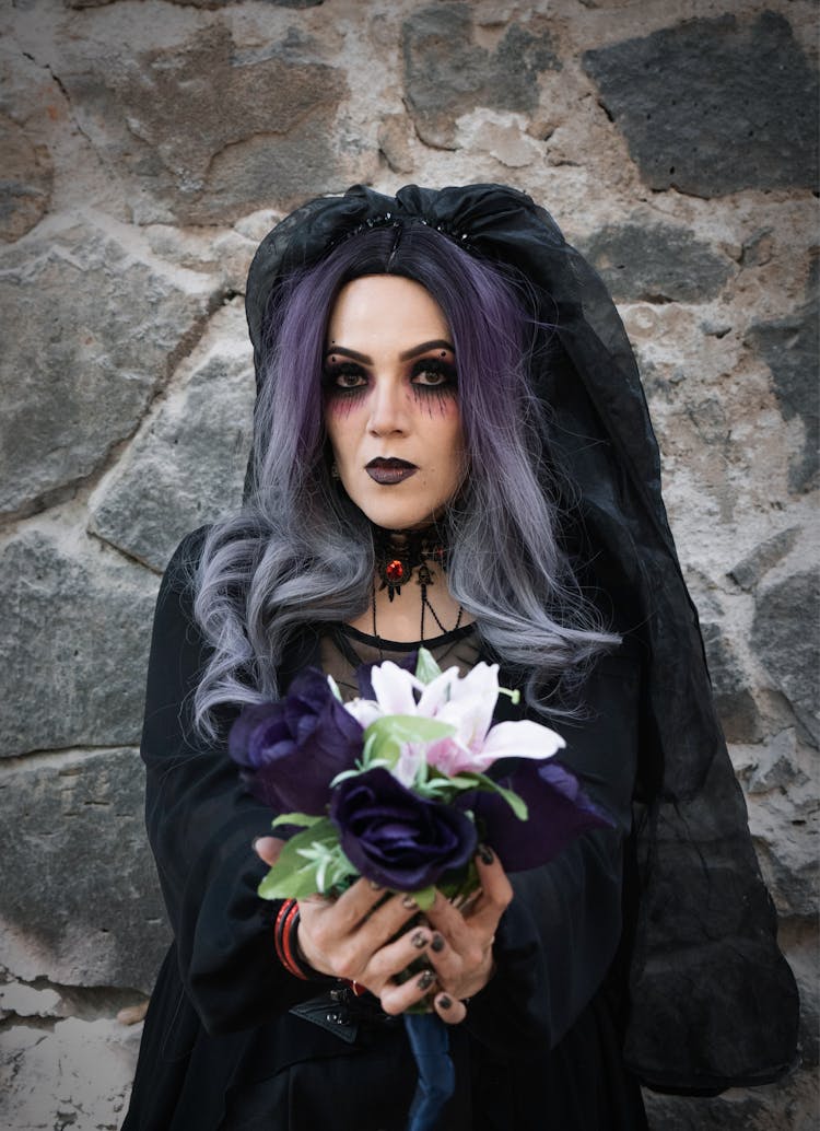 Woman In Costume And With Flowers For Dia De Muertos