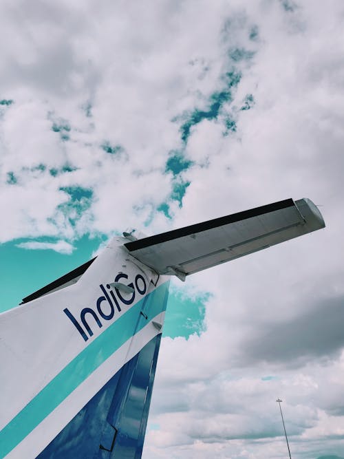 Free Blue and White Indigo Plane Tail Under White Sky Stock Photo