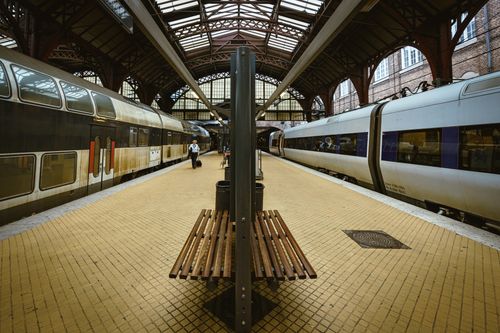 Free View of platforms at Copenhagen's central railway station with trains on both sides. Stock Photo