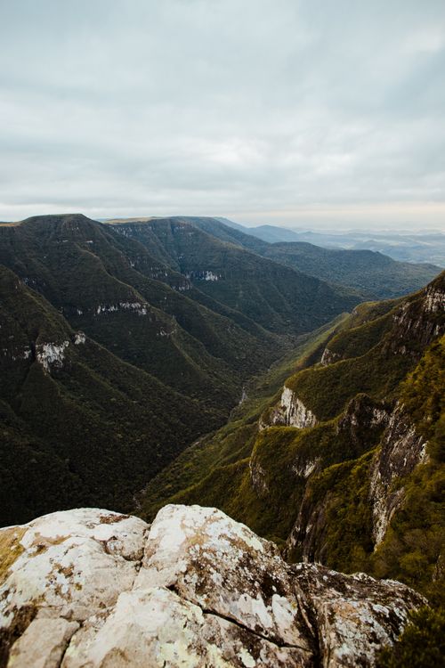 Free Stunning view of a vast mountain valley with overlapping ridges under overcast skies, perfect for nature lovers. Stock Photo