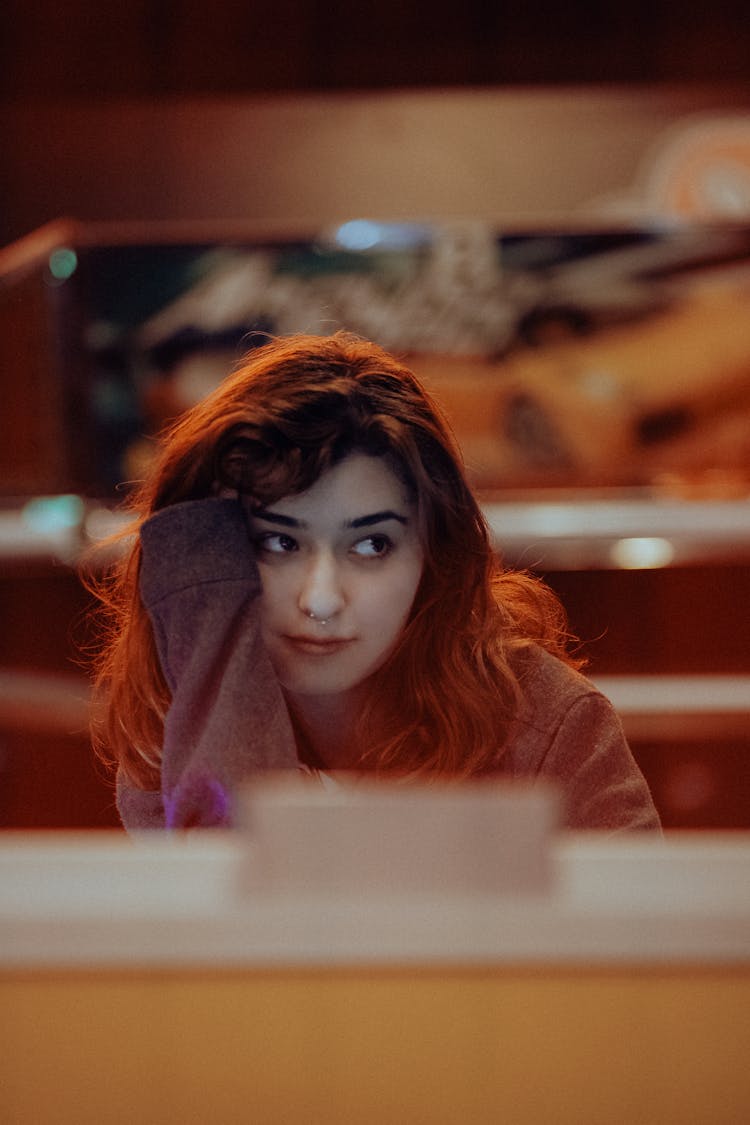 A Young Woman Sitting In A Bar