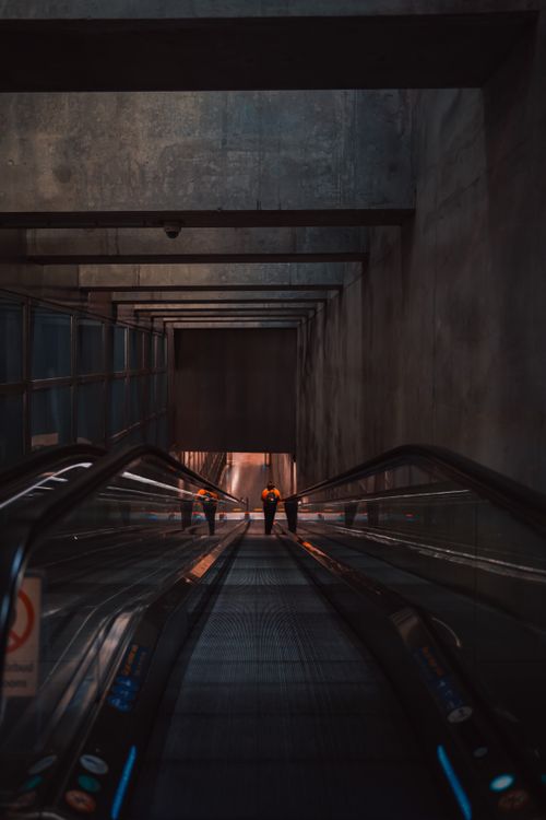 Free A dimly lit subway escalator in Copenhagen offers a compelling urban perspective. Stock Photo