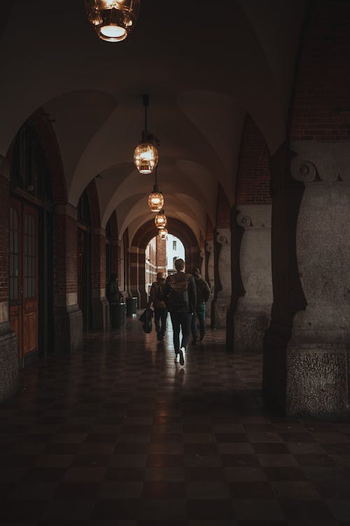 People Walking By Under Arcades