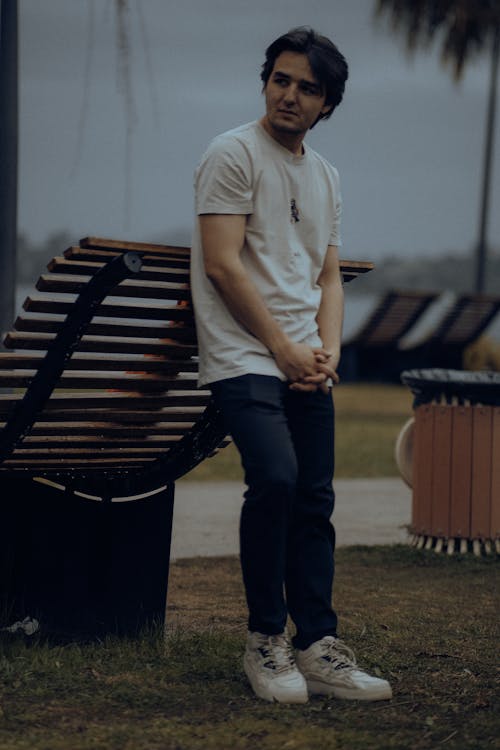 Man Leaning on Wooden Modern Bench