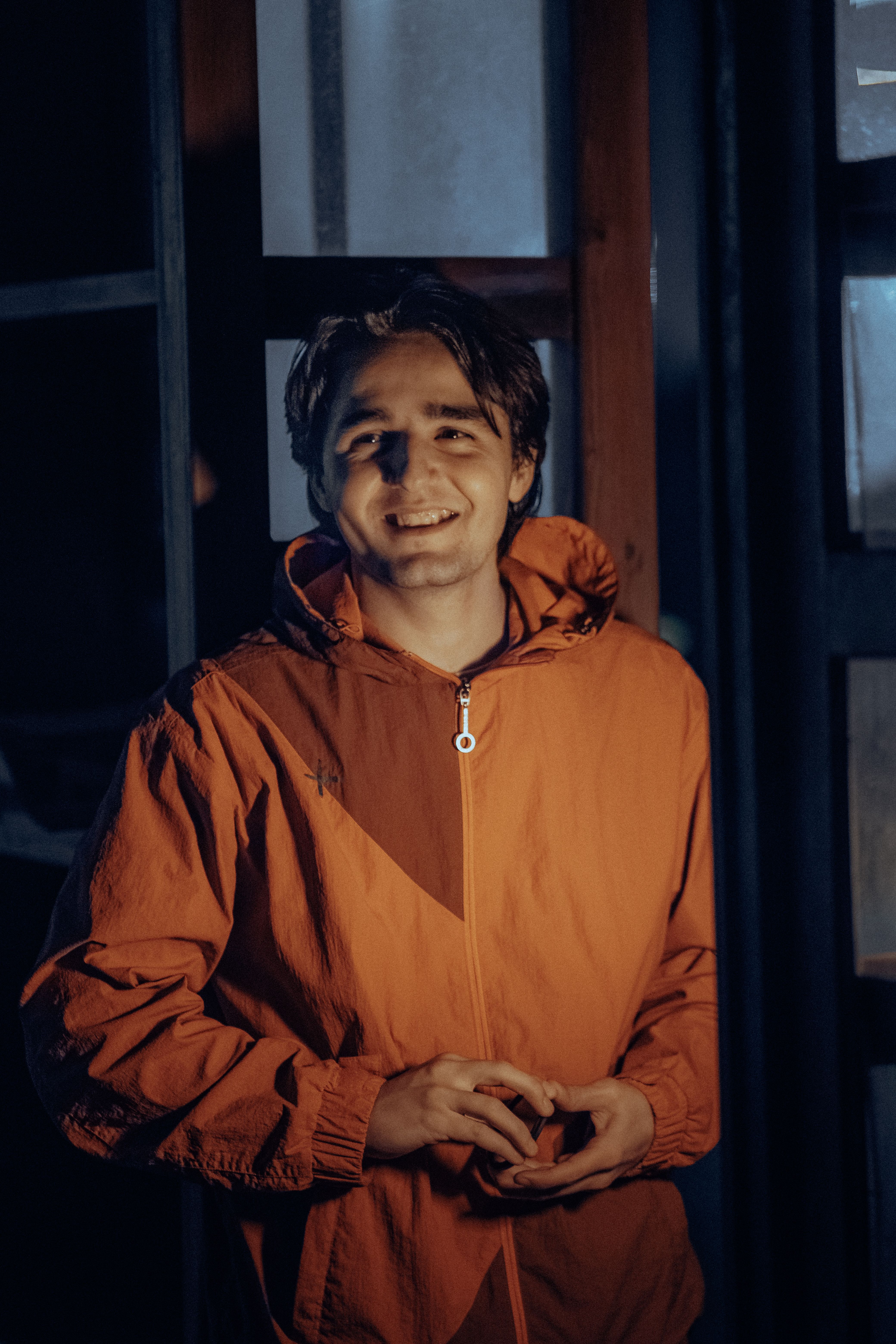A Smiling Man in an Orange Jacket · Free Stock Photo