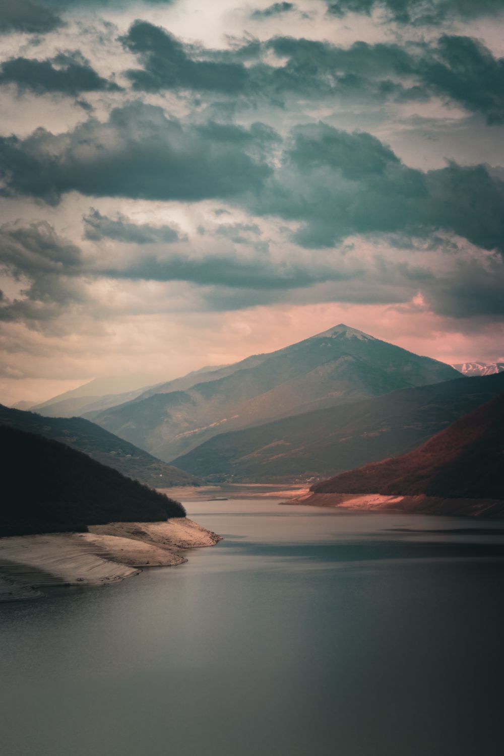 Scenic View of Mountains and a Lake under a Dramatic Sky at Dusk · Free ...