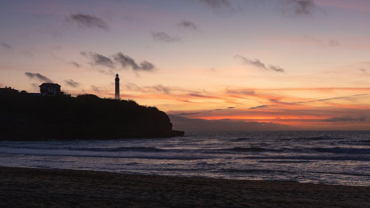 Silhouette Of Lighthouse At Dusk