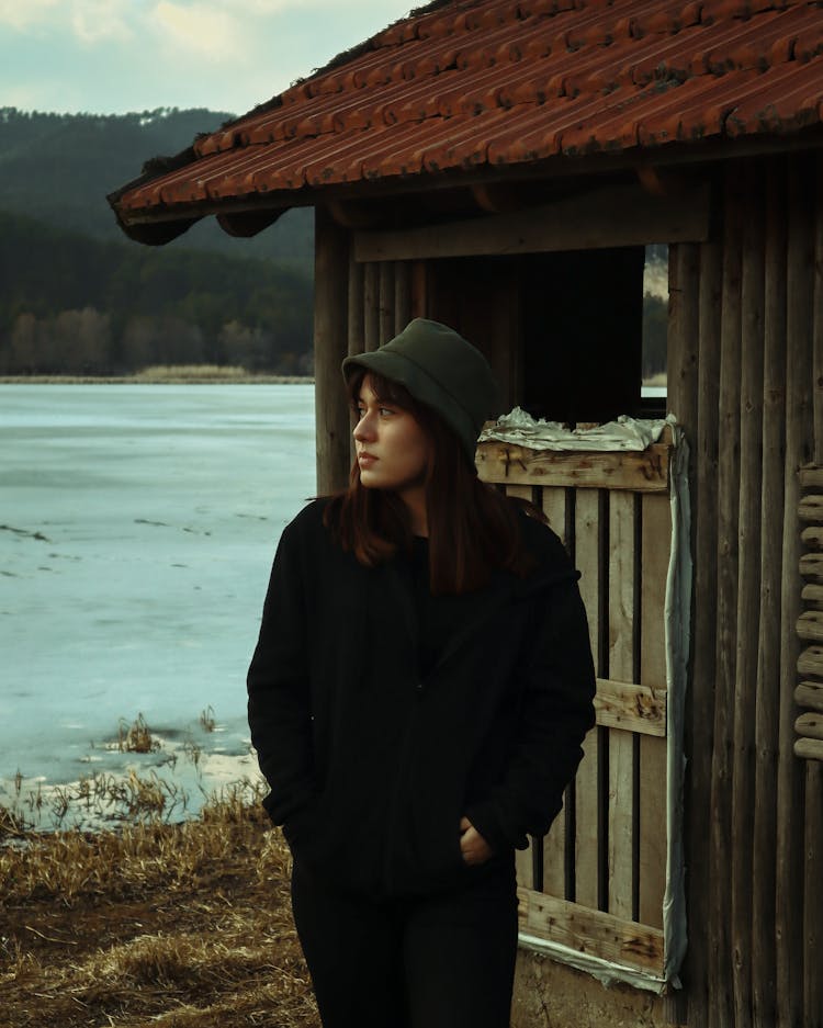 Woman Standing Near Wooden Shed