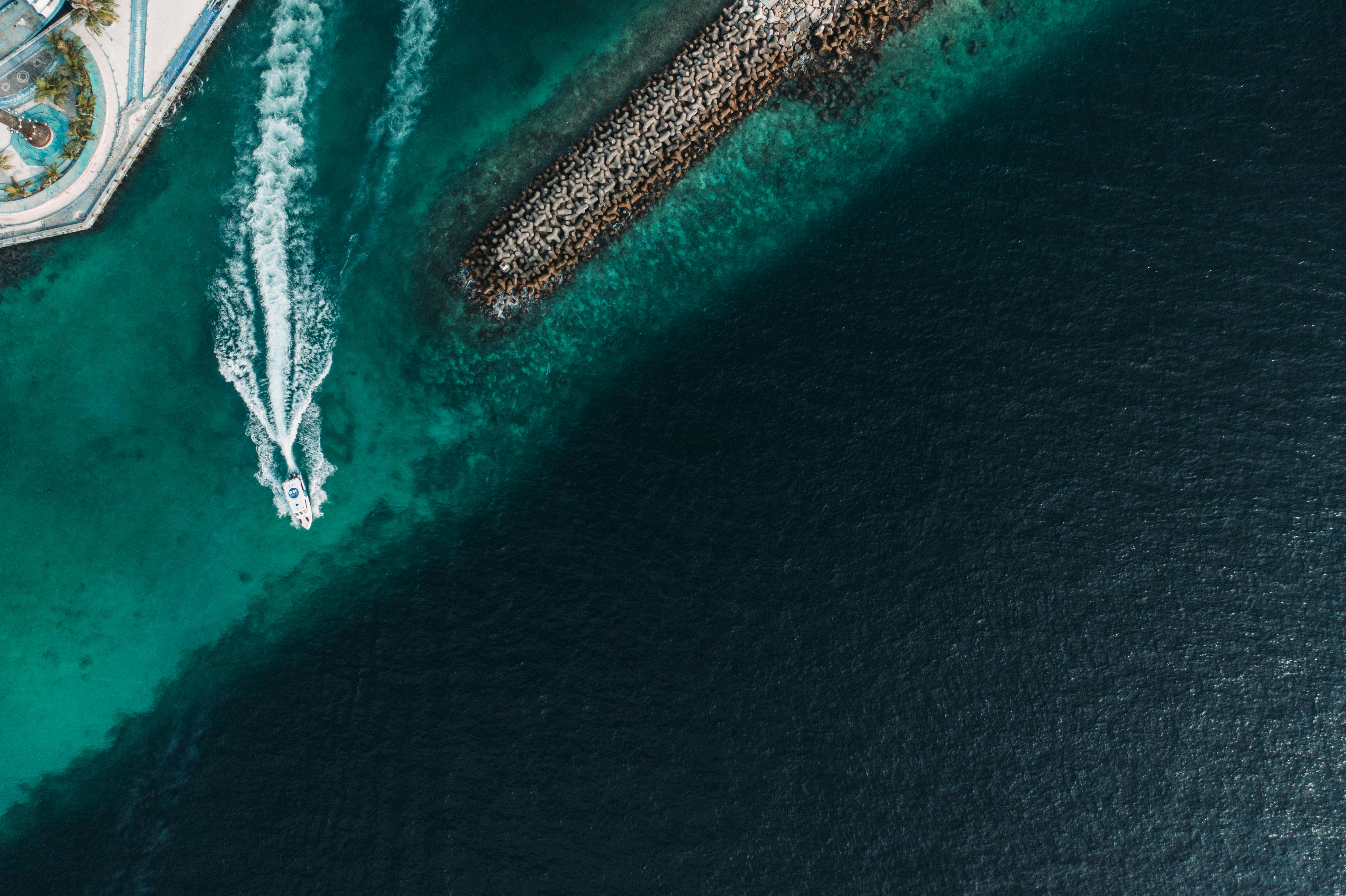 Motorboat Sailing out of Harbor · Free Stock Photo