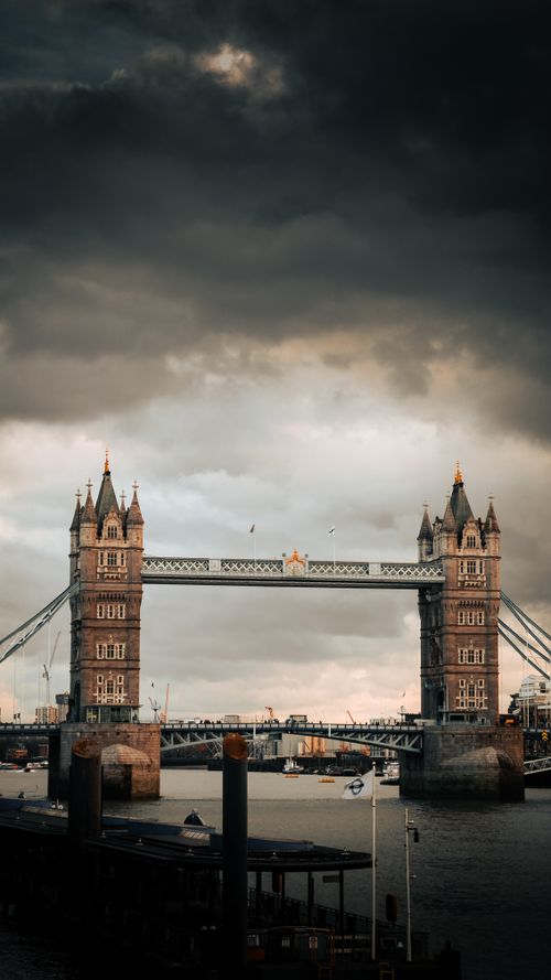 Free A stunning view of Tower Bridge in London with a dramatic sky and river Thames. Stock Photo