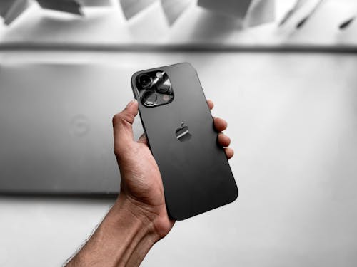 A person holding up an iphone 11 case