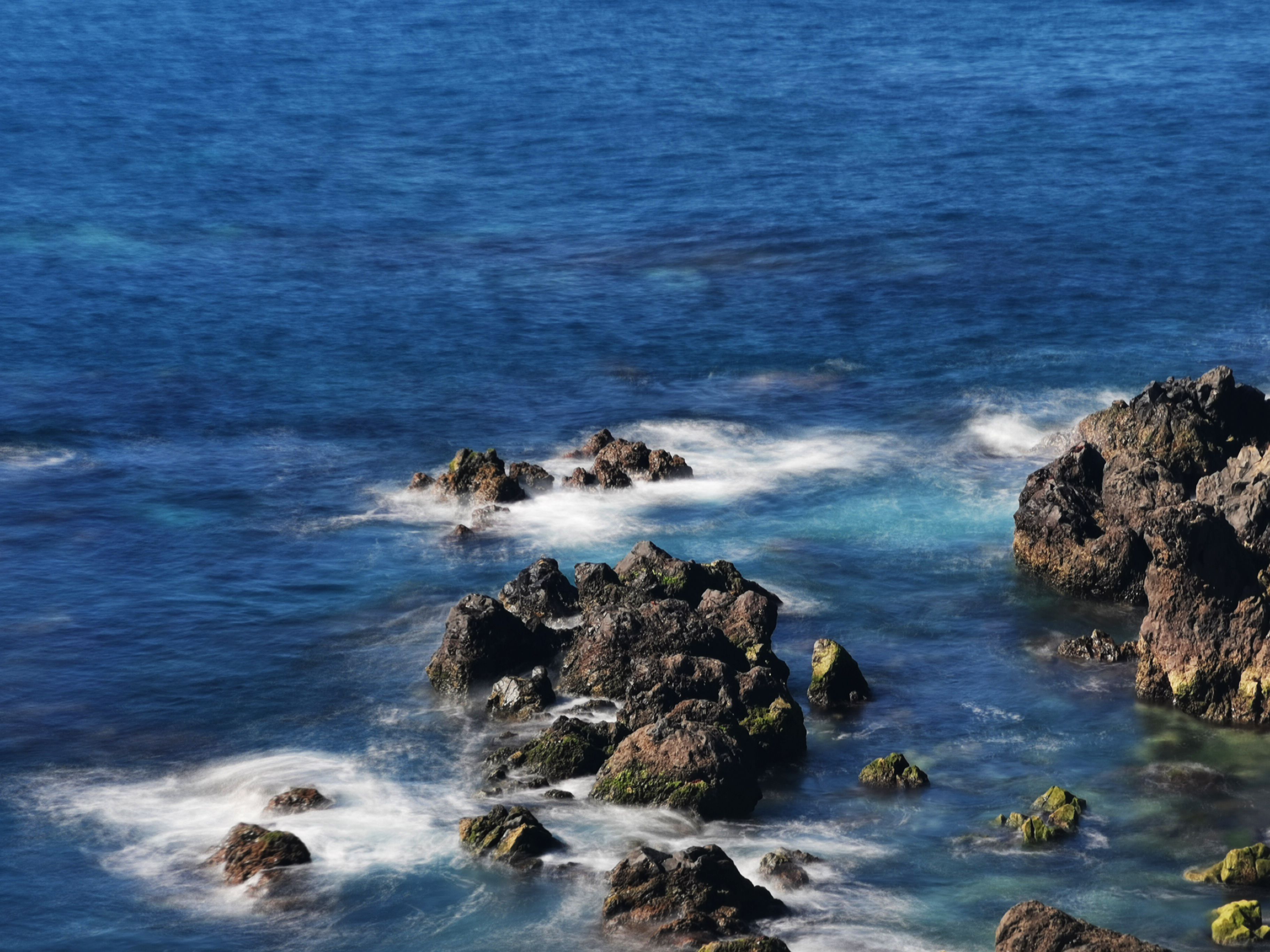 Sunlit Rocks on Sea Shore · Free Stock Photo