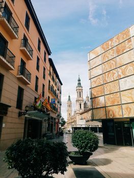 View of Zaragoza's Basilica with urban architecture under a bright sky, capturing the charm of the city.