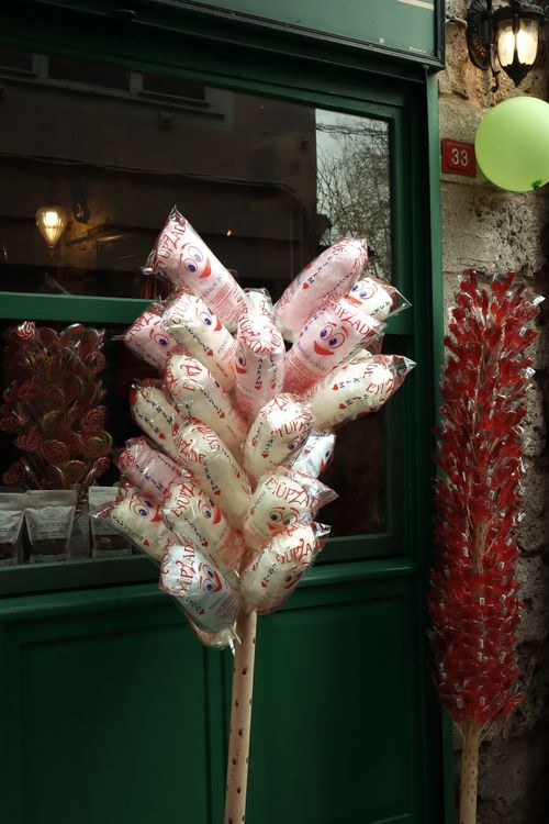 Free Vertical shot of a storefront with a vibrant assortment of cotton candy bags and lollipops. Stock Photo