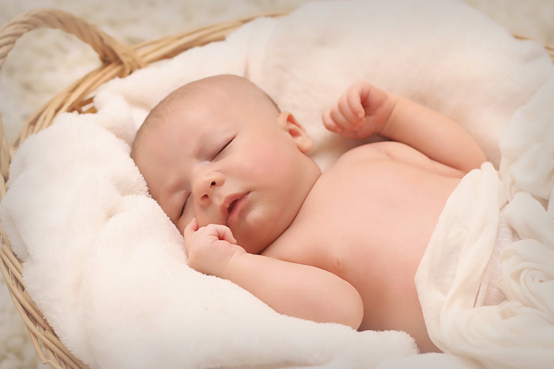 Baby Sleeping on White Cotton