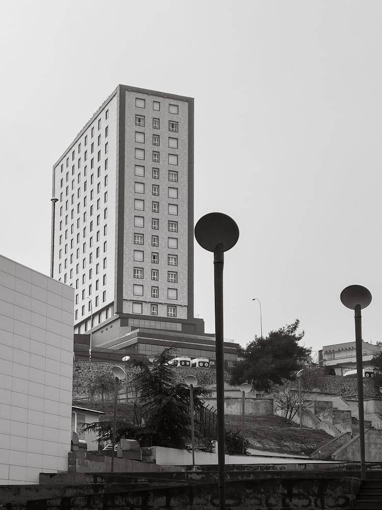 Black And White Photo Of Hotel Building On Top Of Hill