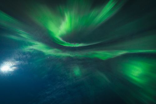 Free Vibrant aurora borealis with green hues illuminating the night sky. Stock Photo