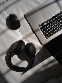 A clean workspace with a laptop and headphones, perfect for tech enthusiasts.