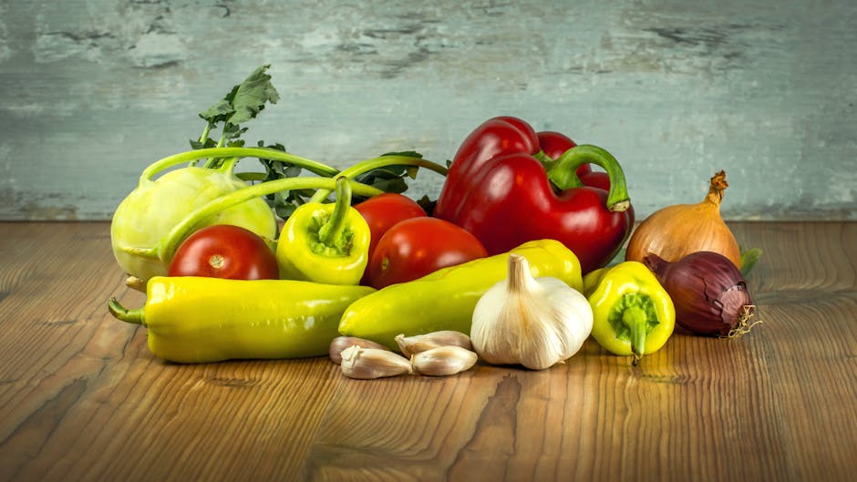 Garlic Beside Ginger and Pepper on Brown Wooden Table