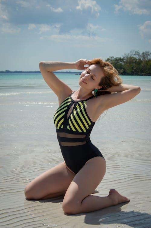 Model Posing in Swimming Costume at Beach