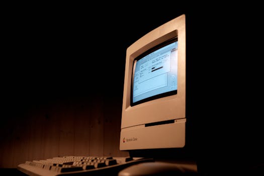 Close-up of a Macintosh Classic computer, showcasing vintage technology and nostalgia.