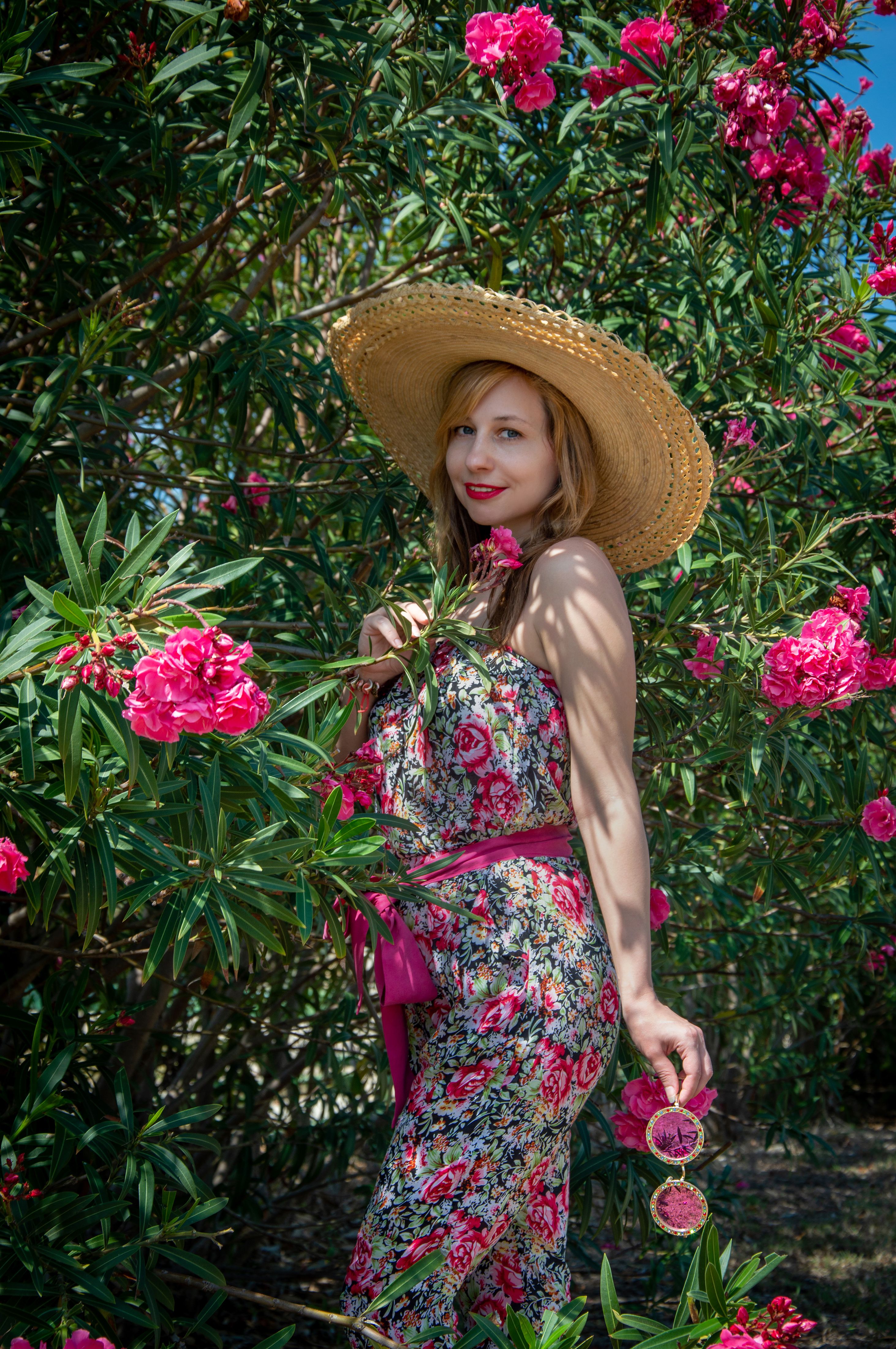 Woman in Straw Hat and Floral Pattern Dress Posing in front of an Old ...