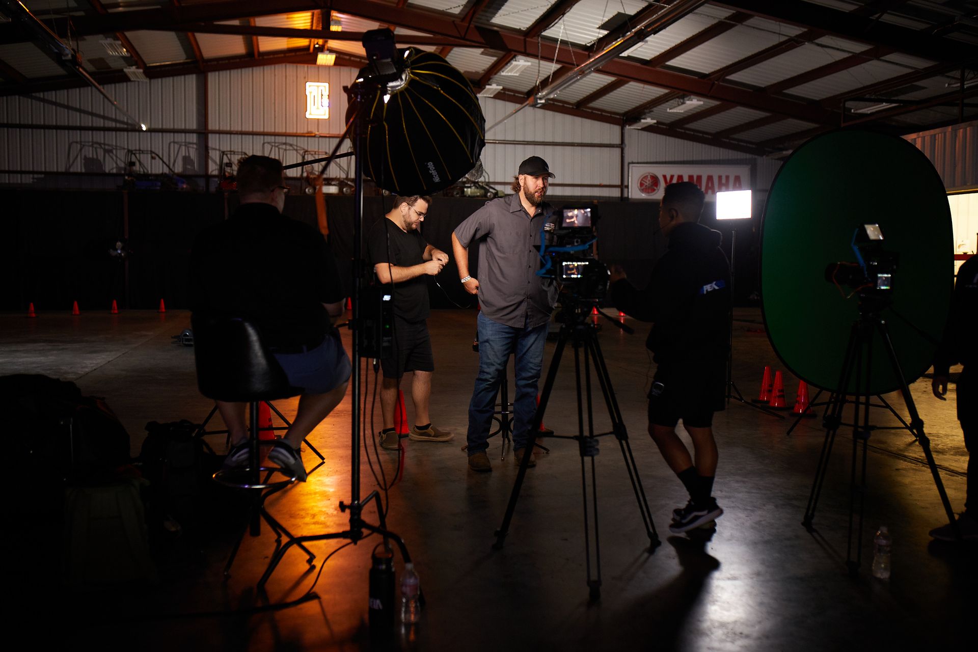 Photographers set up in a warehouse studio with lighting and camera equipment in Orlando, Florida.
